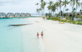 Aerial View of Couple at the beach at Fushifaru Maldives Boutique Resort