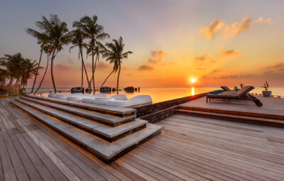 Sunset at the infinity pool at Fushifaru Maldives Boutique Resort