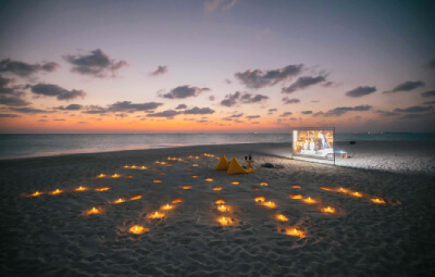 Couple watching movie at the beach