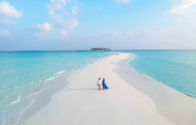 Couple at the sandbank in Fushifaru Maldives Boutique Resort