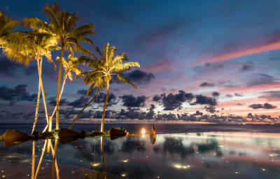 Sunset at the infinity pool at Fushifaru Maldives Boutique Resort